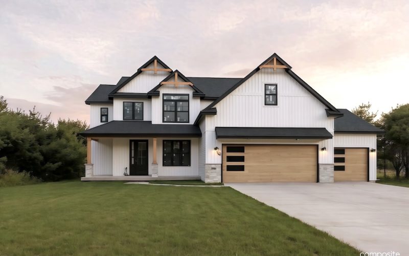 Modern two-story house with white siding, black trim, wood accents, and a three-car garage, set on a green lawn with trees in the background.